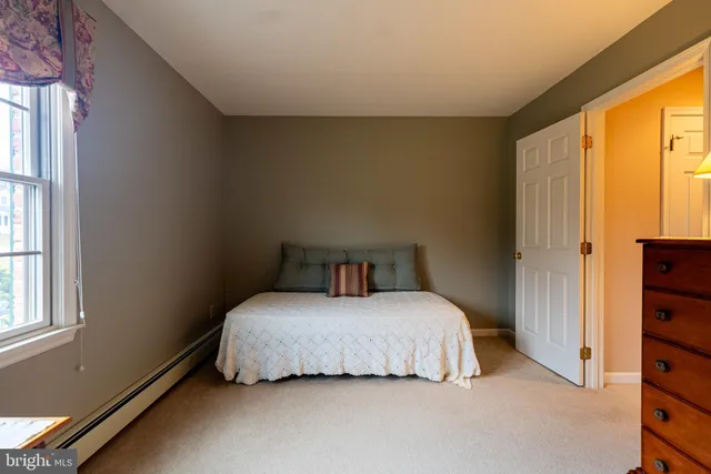 a bedroom with two beds and a window