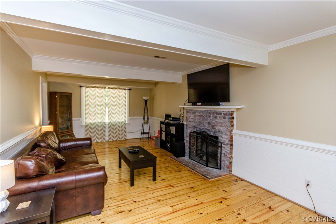 9818 Kendrick Road North Chesterfield, VA 23236 - Photo 3 of 36 a living room with furniture a flat screen tv and a fireplace