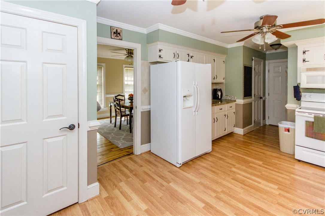 9818 Kendrick Road North Chesterfield, VA 23236 - Photo 8 of 36 a view of a kitchen from the hallway with a wooden floor