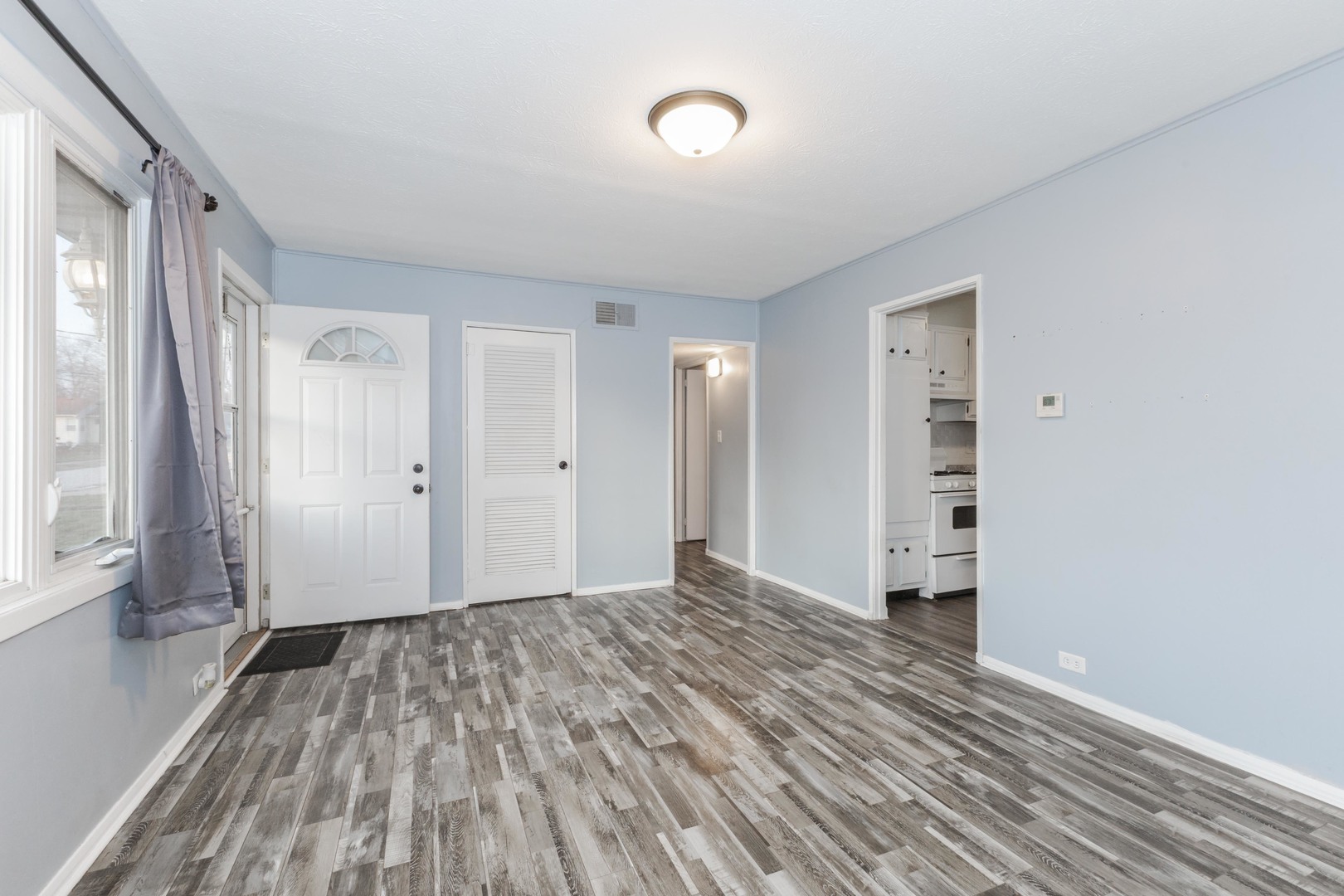 334 East Baker Street Bloomington, IL 61701 - Photo 5 of 32 a view of empty room with wooden floor