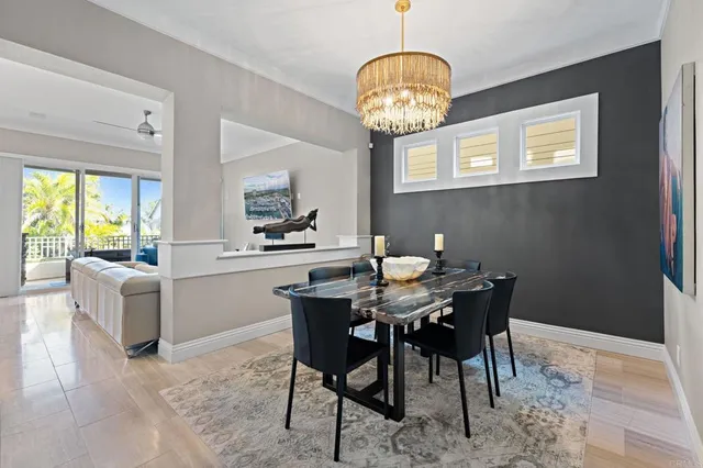 a view of a dining room with furniture a chandelier and wooden floor