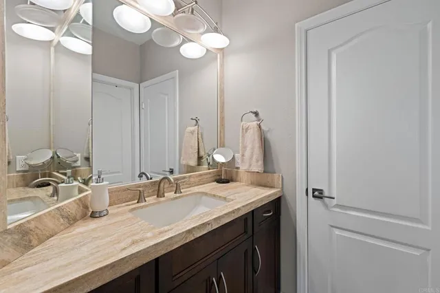 a bathroom with a sink vanity and a mirror