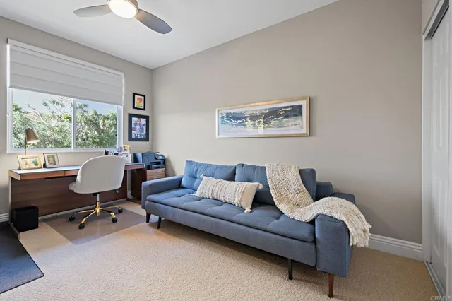 a living room with furniture rug and a window