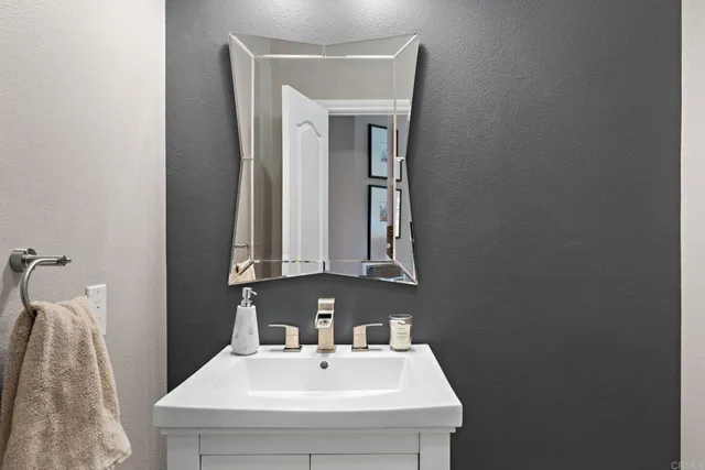 a bathroom with a sink a vanity and a mirror