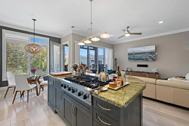 a kitchen with stainless steel appliances granite countertop a stove and a wooden floors
