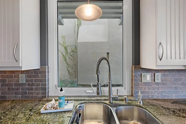 a kitchen with a sink and a mirror