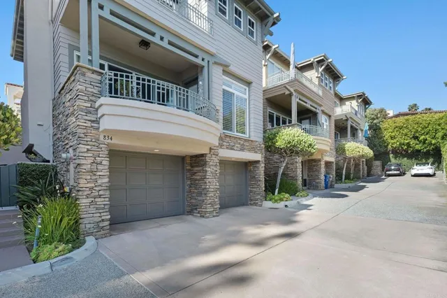 front view of a brick house with potted plants