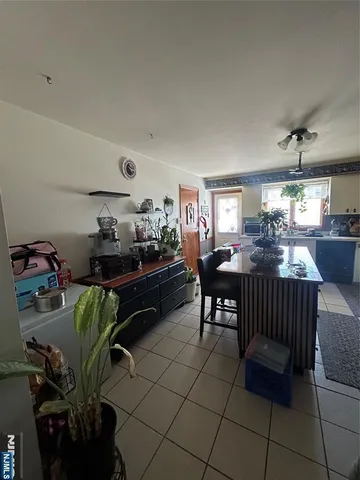 a outdoor kitchen with a table and chairs