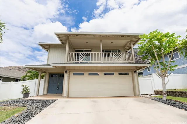 a front view of a house with a garden and garage