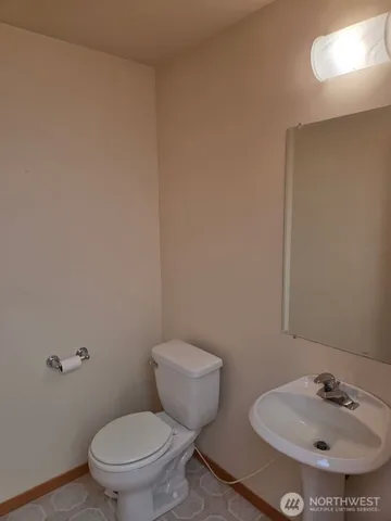 a bathroom with a toilet and a sink