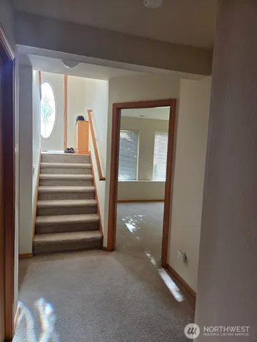a view of an entryway with wooden floor