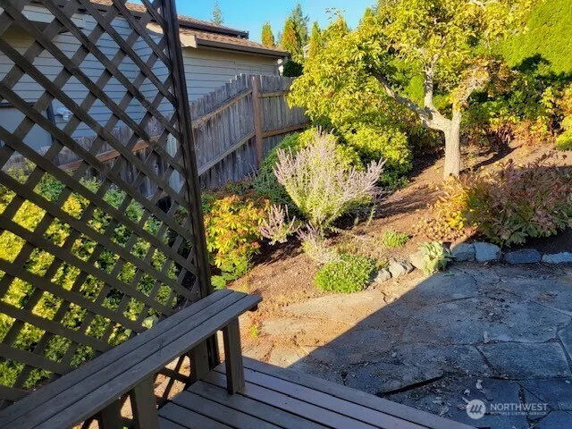 a wooden bench sitting in front of a house