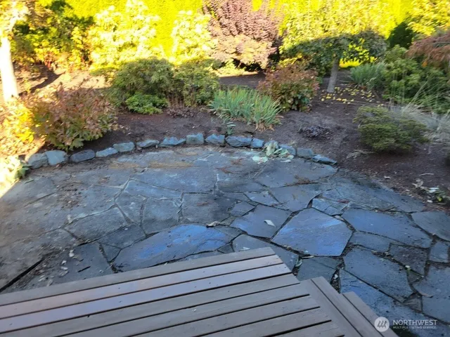 a view of a backyard with wooden fence