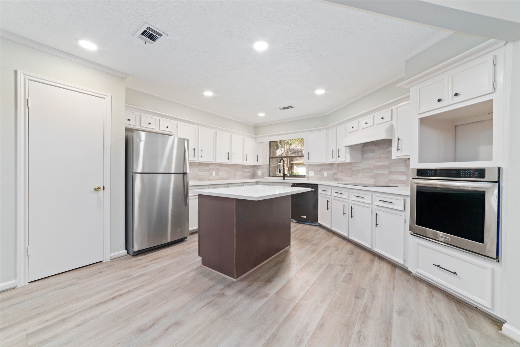 154 Old Bridge Lake Street Houston, TX 77069 - Photo 21 of 30 a kitchen with kitchen island a sink stainless steel appliances and cabinets