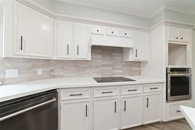 a kitchen with white cabinets and white appliances