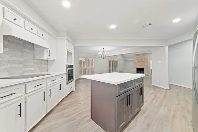 a kitchen with granite countertop a sink and a stove
