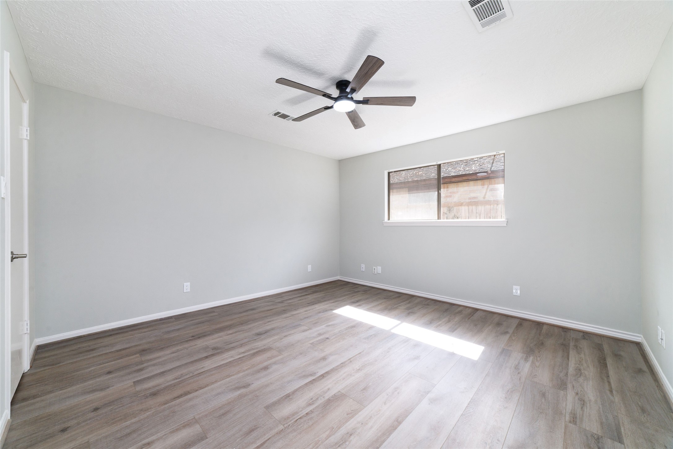154 Old Bridge Lake Street Houston, TX 77069 - Photo 26 of 30 an empty room with wooden floor fan and windows