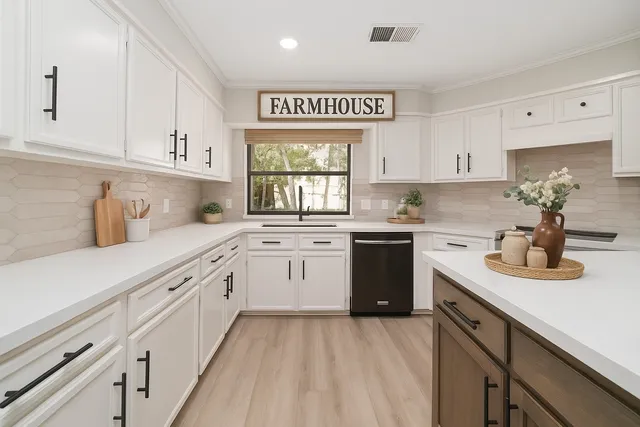 a kitchen with cabinets appliances a sink and a window