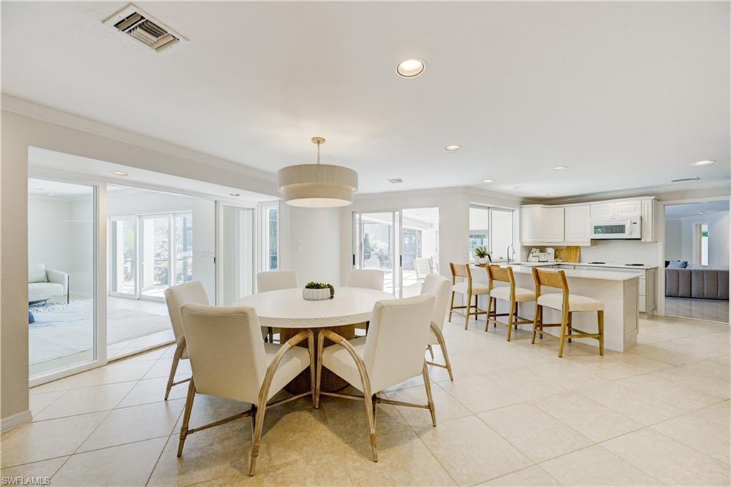 660 14th Avenue South Naples, FL 34102 - Photo 11 of 50 a view of a dining room with furniture and a chandelier