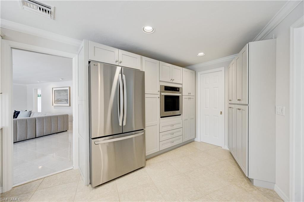 660 14th Avenue South Naples, FL 34102 - Photo 15 of 50 a kitchen with stainless steel appliances a refrigerator sink and microwave