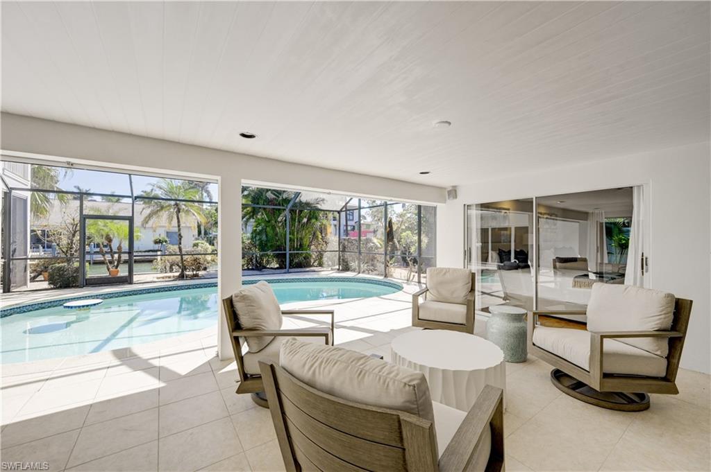 660 14th Avenue South Naples, FL 34102 - Photo 19 of 50 a living room with furniture and large windows