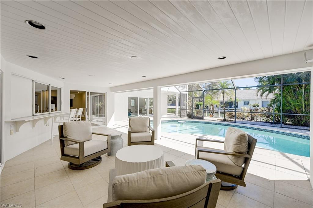 660 14th Avenue South Naples, FL 34102 - Photo 20 of 50 a living room with furniture and a large window
