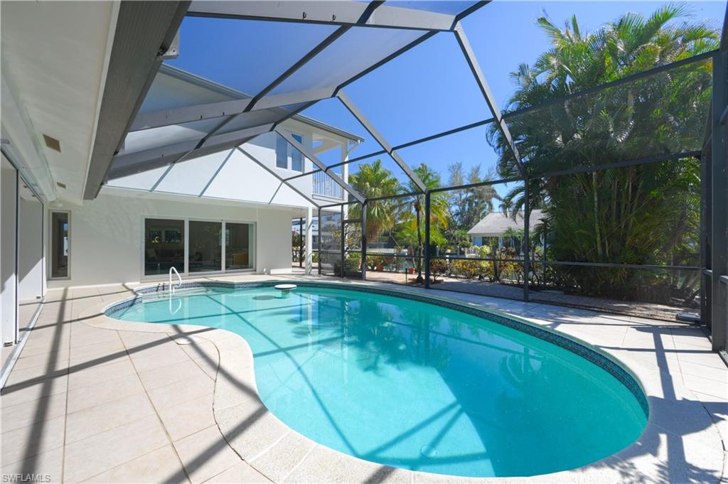 660 14th Avenue South Naples, FL 34102 - Photo 21 of 50 a swimming pool with outdoor seating