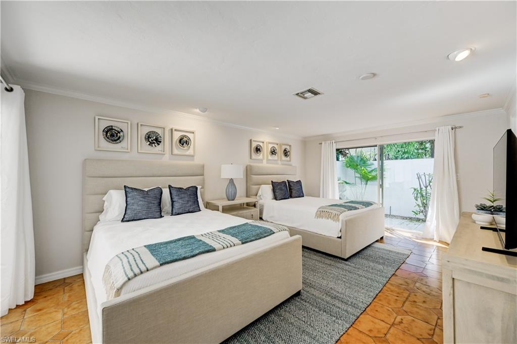 660 14th Avenue South Naples, FL 34102 - Photo 28 of 50 a living room with furniture and a flat screen tv