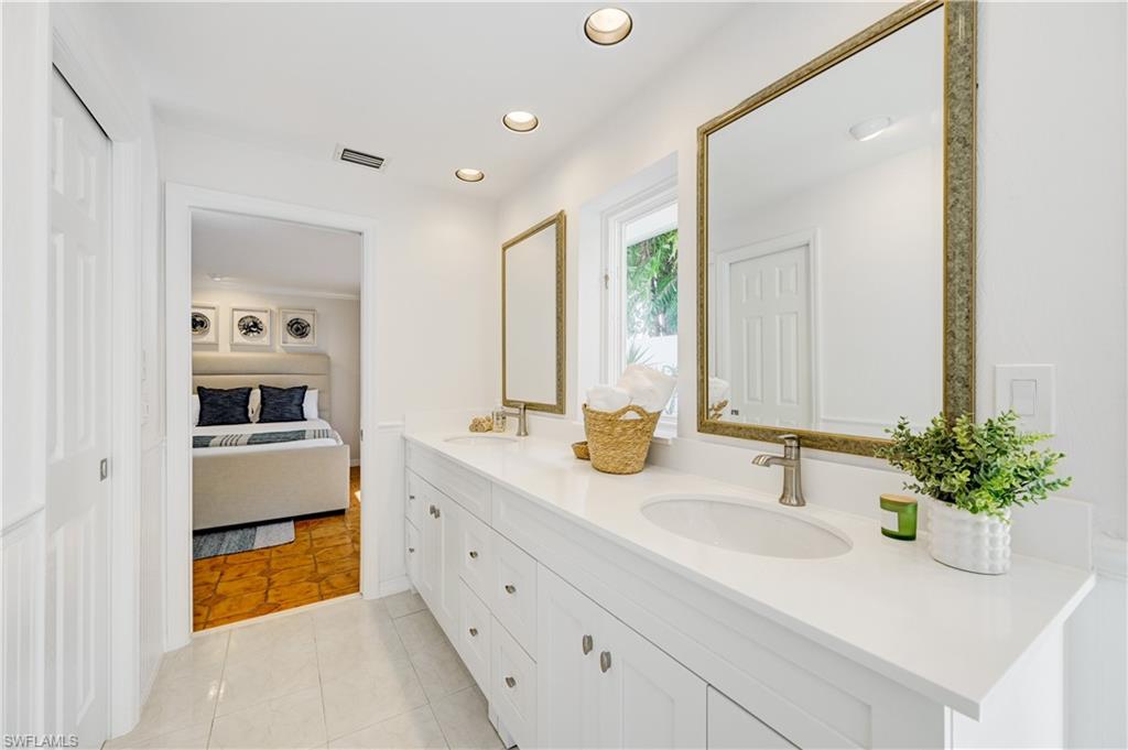 660 14th Avenue South Naples, FL 34102 - Photo 29 of 50 a bathroom with a sink and a mirror