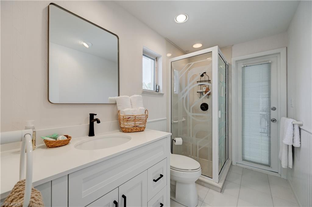 660 14th Avenue South Naples, FL 34102 - Photo 32 of 50 a bathroom with a sink a toilet and shower