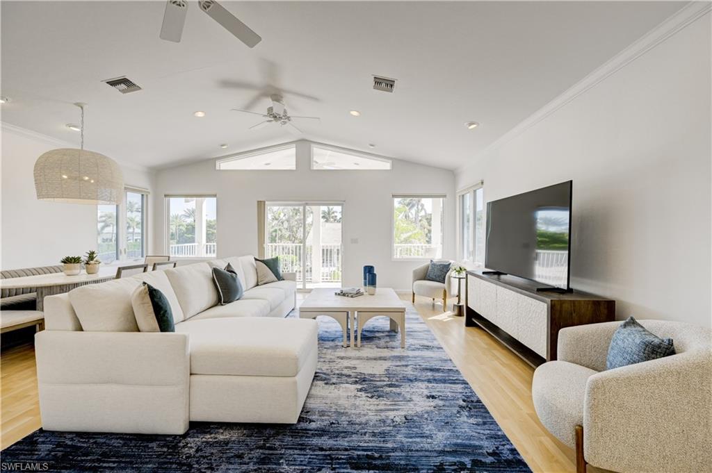 660 14th Avenue South Naples, FL 34102 - Photo 39 of 50 a living room with furniture wooden floor and a flat screen tv