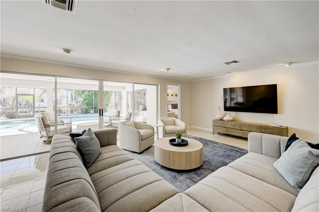660 14th Avenue South Naples, FL 34102 - Photo 7 of 50 a living room with furniture and a flat screen tv