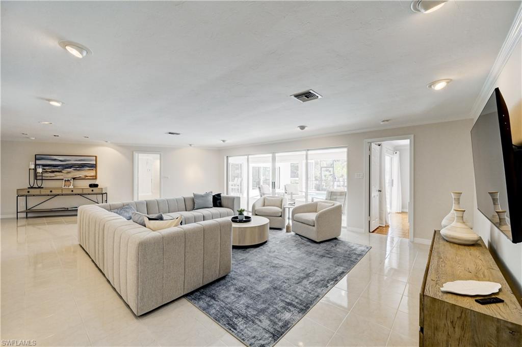 660 14th Avenue South Naples, FL 34102 - Photo 8 of 50 a living room with furniture and a flat screen tv
