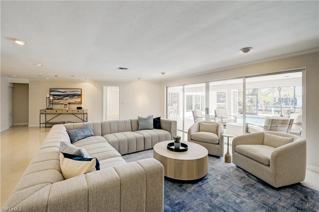 660 14th Avenue South Naples, FL 34102 - Photo 9 of 50 a living room with furniture and a large window