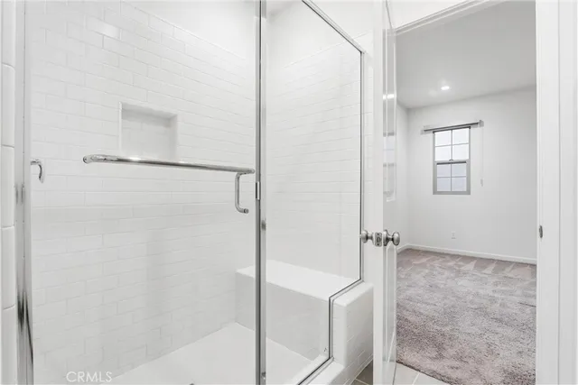 a bathroom with a shower and a glass door