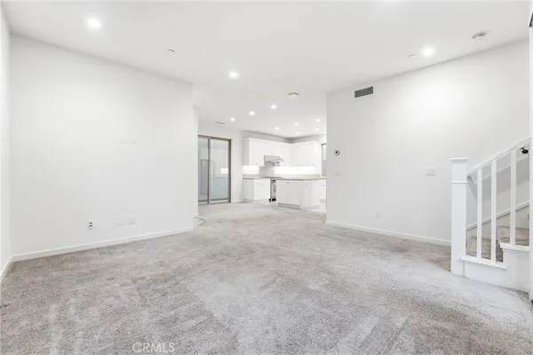 a view of a big room with a kitchen