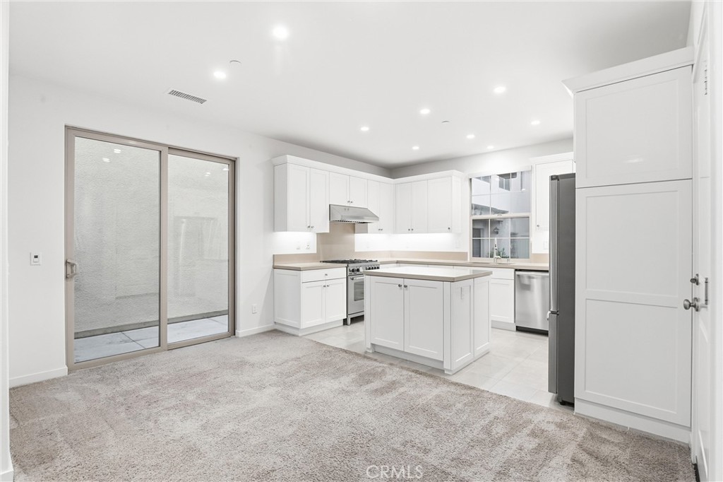 125 Messenger Irvine, CA 92618 - Photo 4 of 19 a kitchen with white cabinets and white appliances