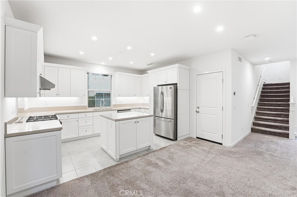 125 Messenger Irvine, CA 92618 - Photo 5 of 19 a kitchen with white cabinets and white appliances