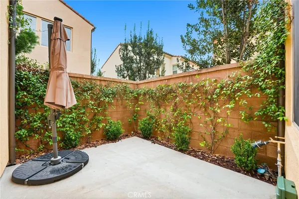 a vase of flowers sitting on a table with chairs