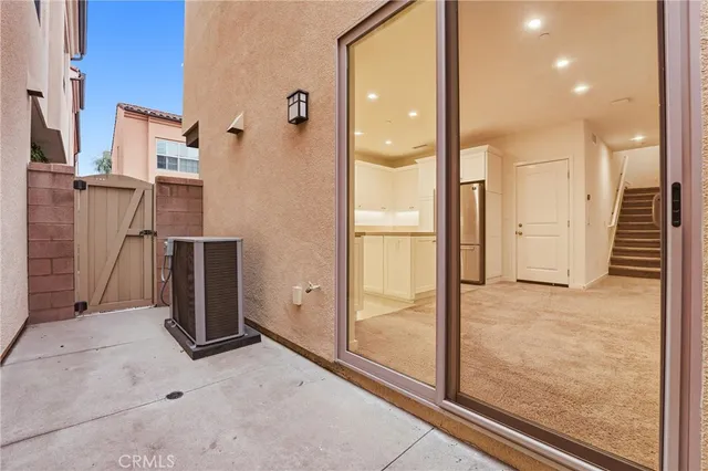 hallway with wooden floor and glass door shower