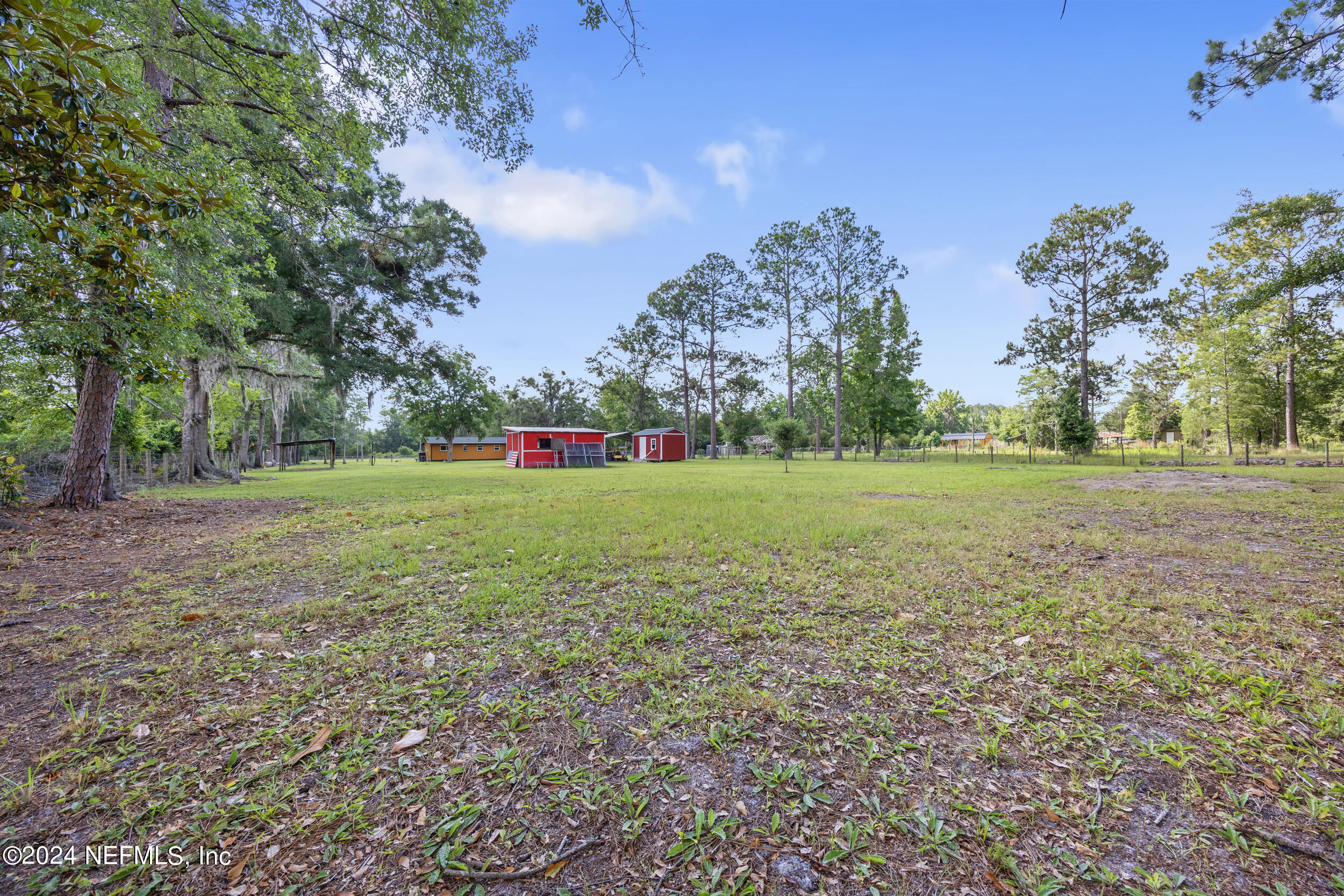 8912 McClelland Road Jacksonville, FL 32234 - Photo 15 of 49 a view of a field with trees in the background