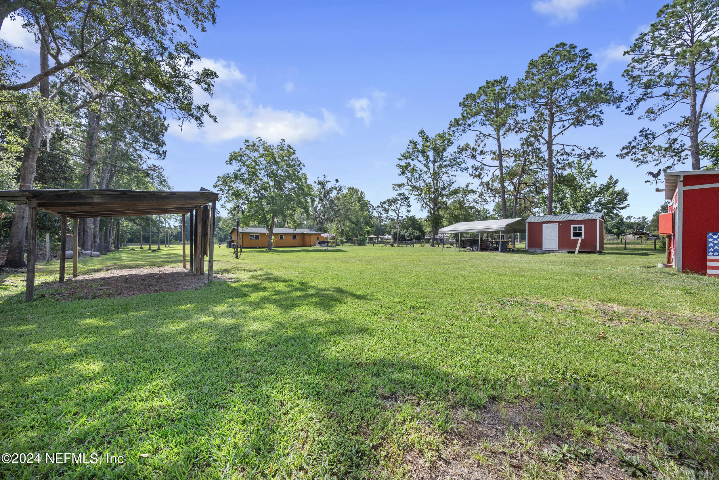 8912 McClelland Road Jacksonville, FL 32234 - Photo 16 of 49 a view of a house with a yard porch and sitting area