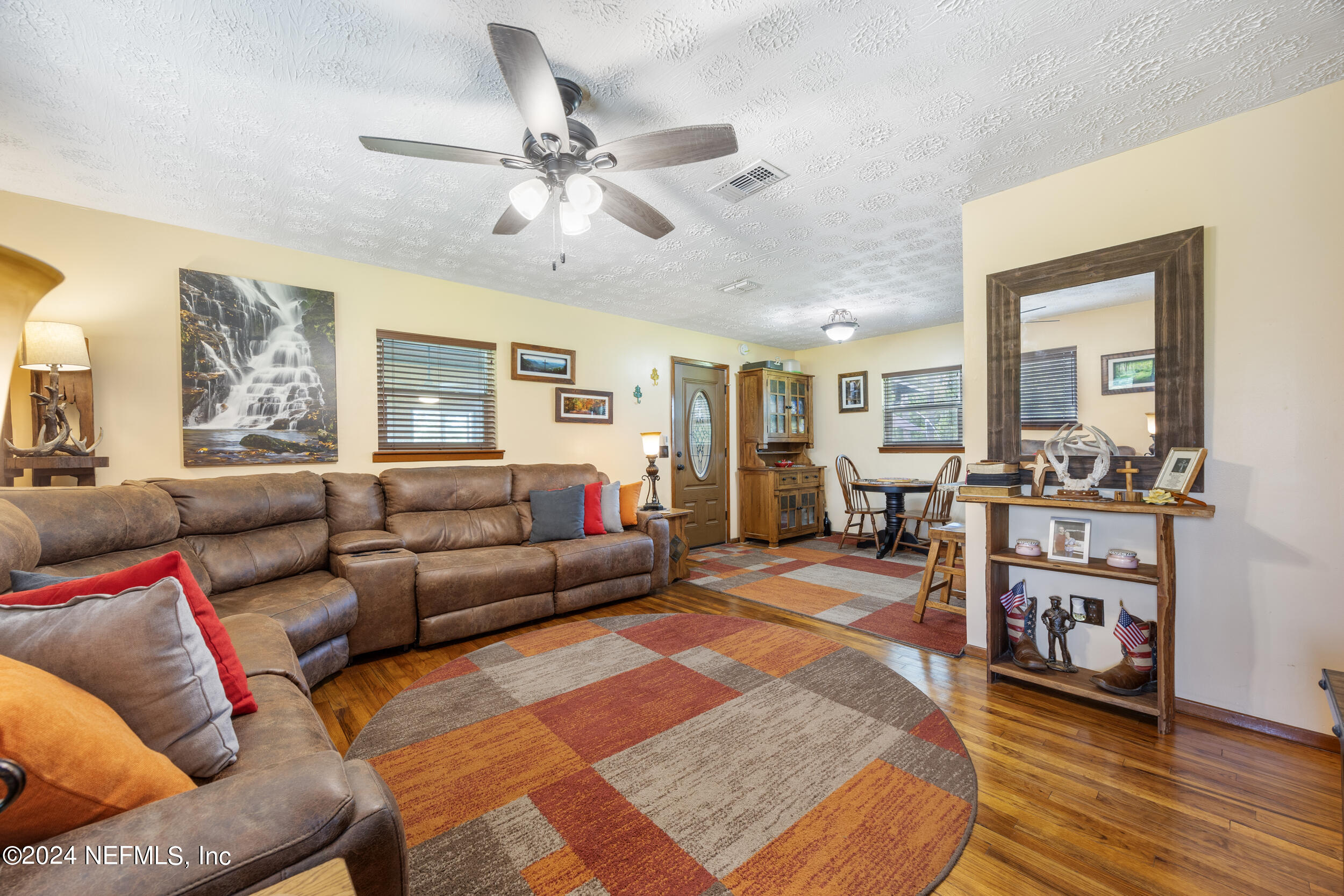 8912 McClelland Road Jacksonville, FL 32234 - Photo 19 of 49 a living room with furniture and wooden floor