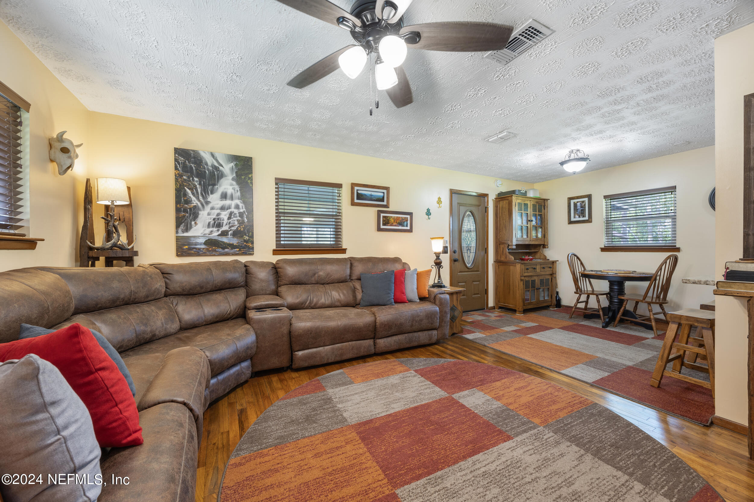 8912 McClelland Road Jacksonville, FL 32234 - Photo 20 of 49 a living room with furniture and a ceiling fan