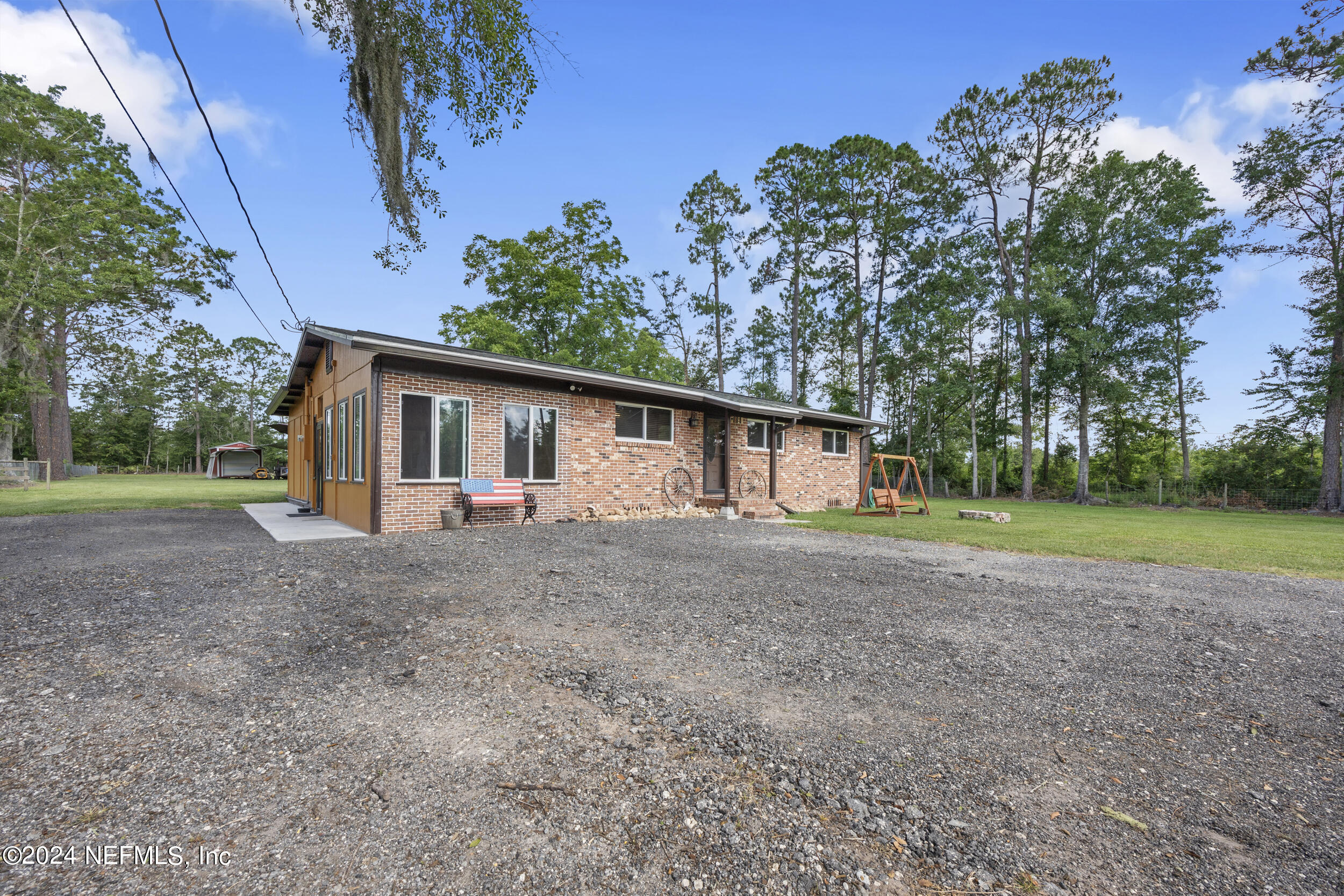 8912 McClelland Road Jacksonville, FL 32234 - Photo 2 of 49 a view of a house with yard and a garden