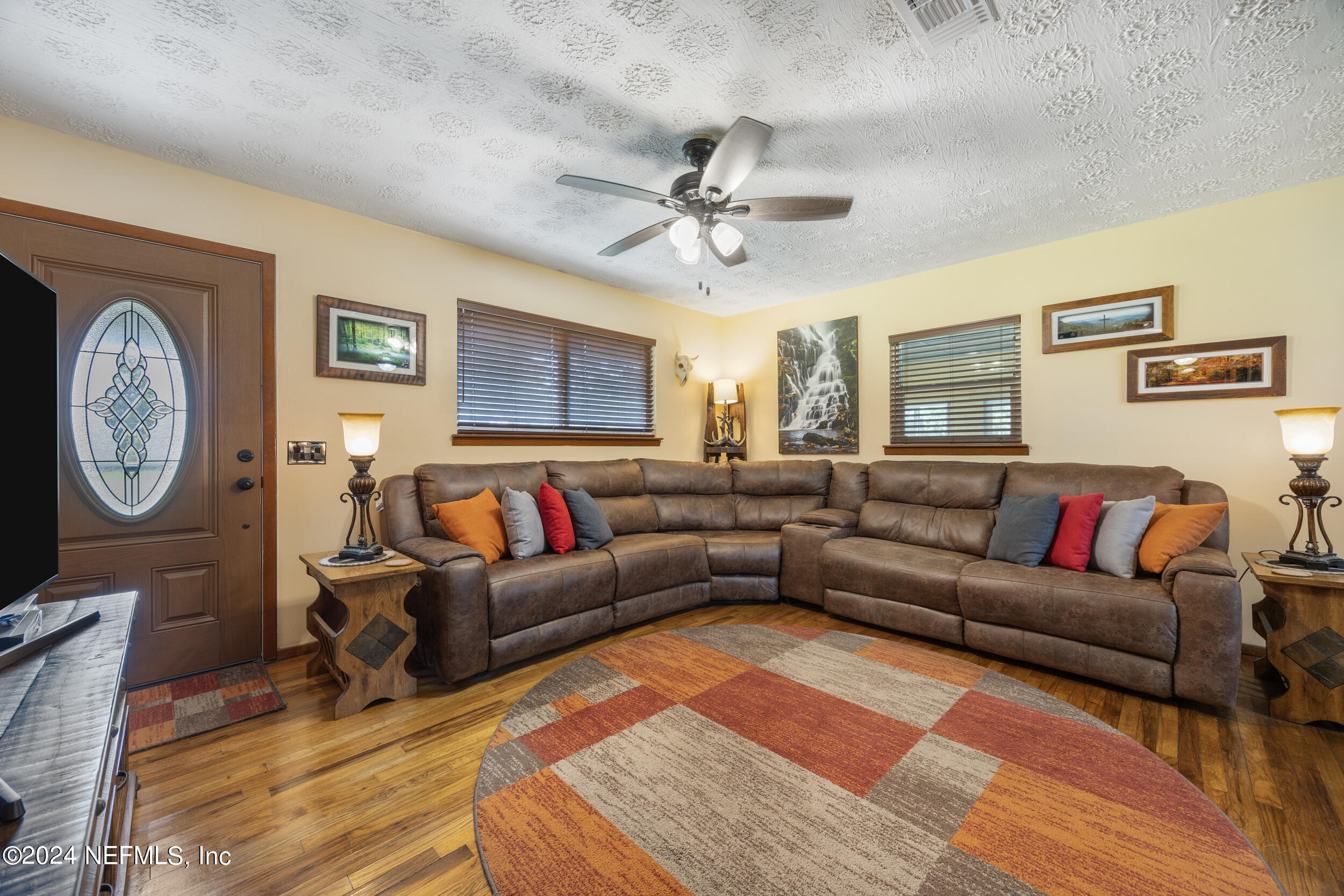8912 McClelland Road Jacksonville, FL 32234 - Photo 21 of 49 a living room with furniture a clock on wall and a window