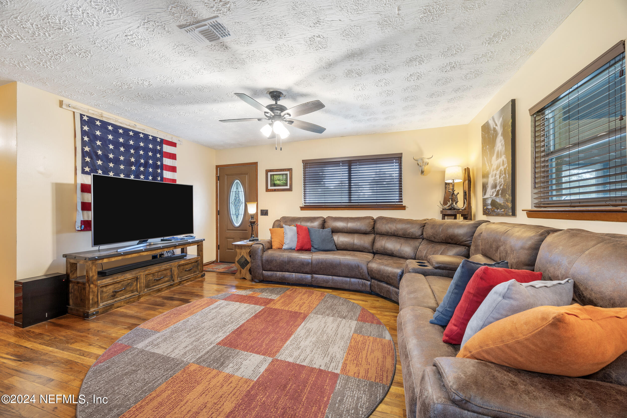 8912 McClelland Road Jacksonville, FL 32234 - Photo 22 of 49 a living room with furniture and a flat screen tv