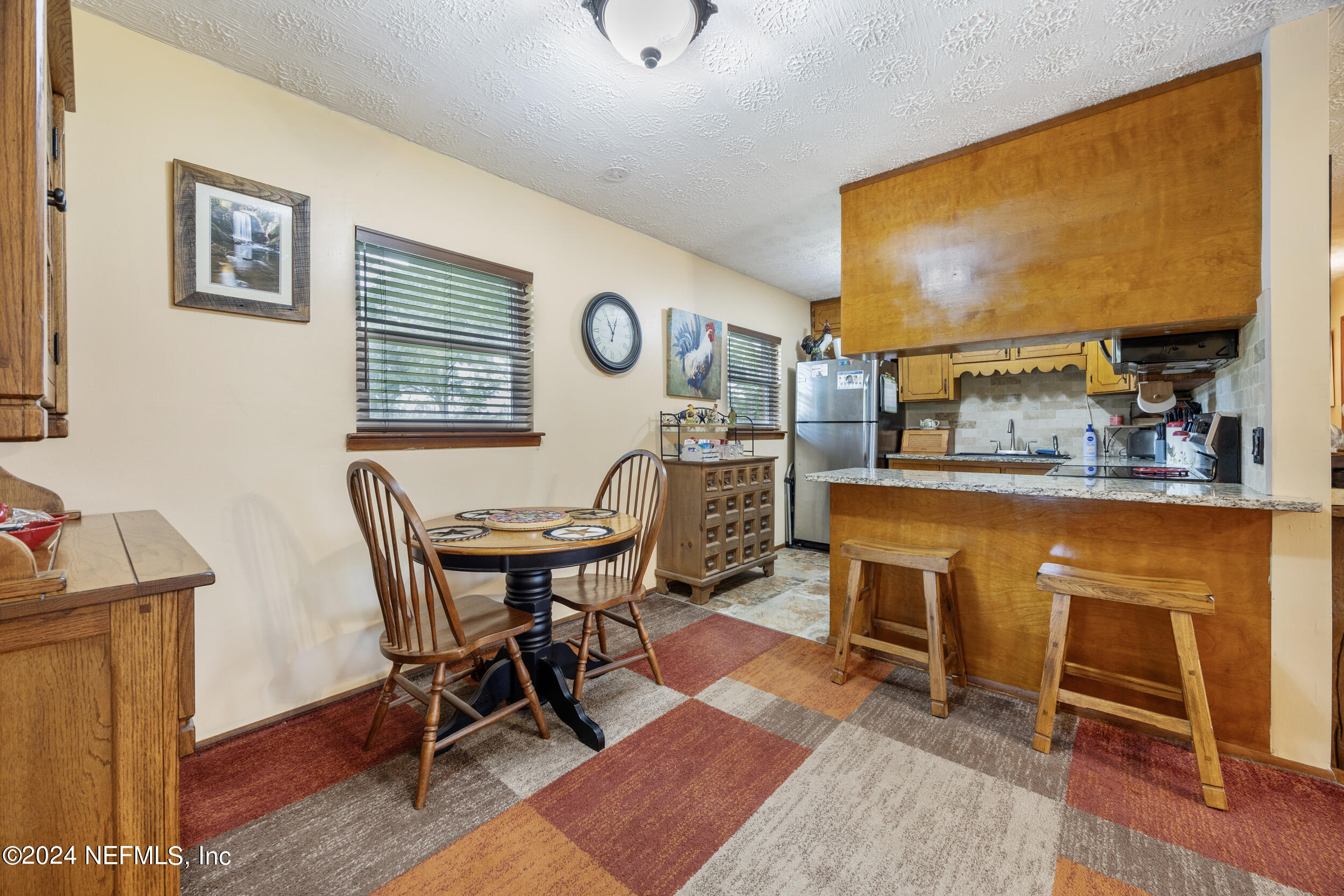 8912 McClelland Road Jacksonville, FL 32234 - Photo 24 of 49 a work room with furniture a rug and a window