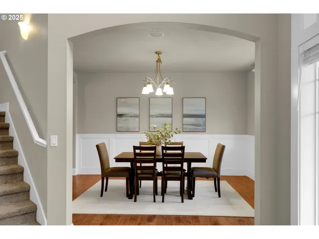 a view of a dining room with furniture and chandelier