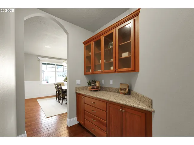 a kitchen with a sink cabinets and dining table